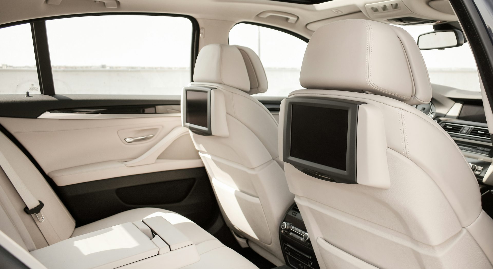 Spacious leather rear seating in a chauffeured luxury vehicle