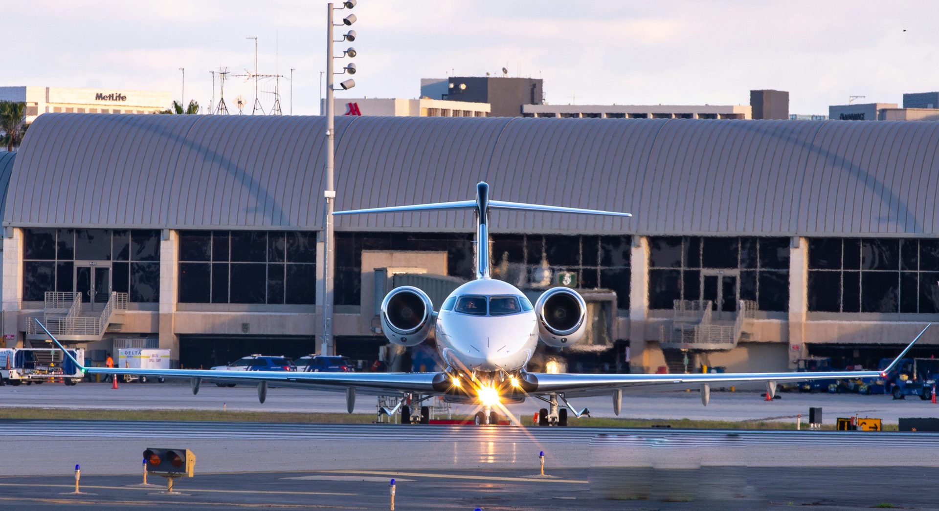 Private jet arriving on the tarmac at sunset
